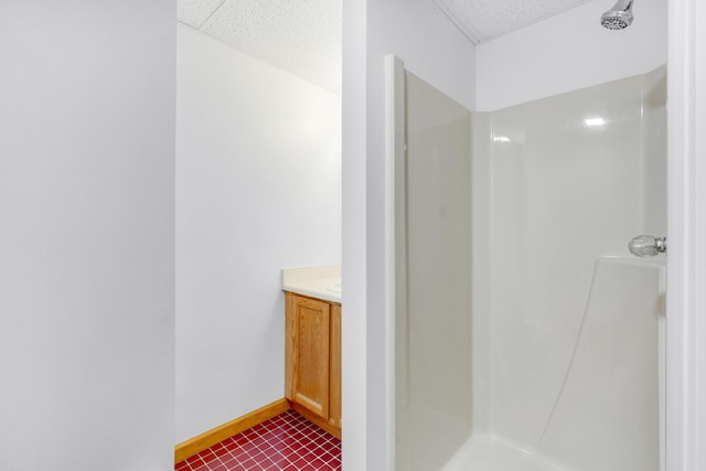 32 Thorne Ave, Lewiston, ME 04240 - bathroom with a shower, vanity, tile patterned flooring, and baseboards