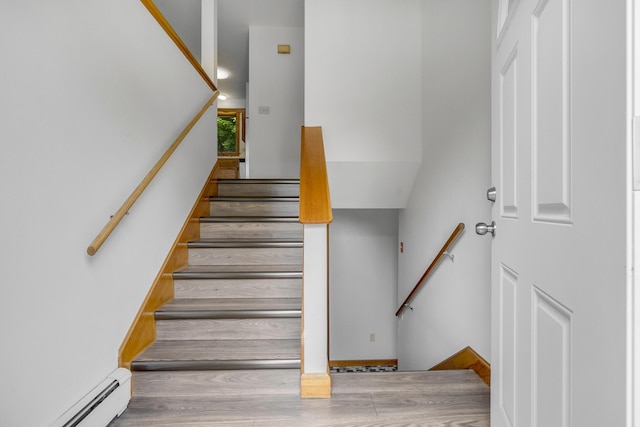 32 Thorne Ave, Lewiston, ME 04240 - stairs with a baseboard radiator and wood finished floors