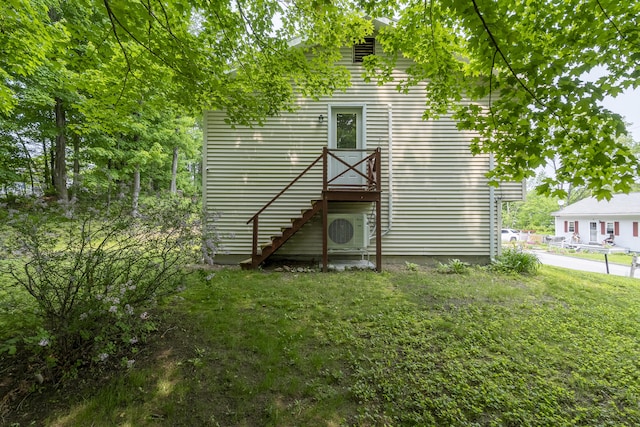 32 Thorne Ave, Lewiston, ME 04240 - view of home's exterior featuring ac unit, stairway, and a lawn