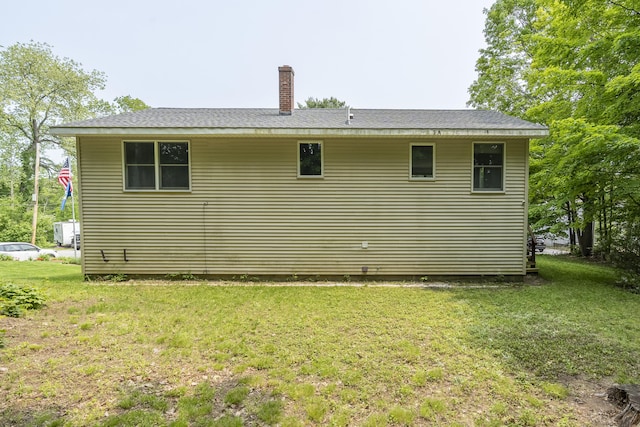 32 Thorne Ave, Lewiston, ME 04240 - view of property exterior with a lawn and a chimney