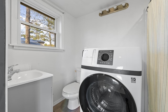 441 Middle Rd, Woolwich, ME 04579 - bathroom with washer / clothes dryer, vanity, toilet, and wood finished floors