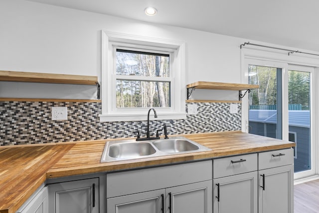 441 Middle Rd, Woolwich, ME 04579 - kitchen featuring butcher block counters, a sink, open shelves, decorative backsplash, and recessed lighting
