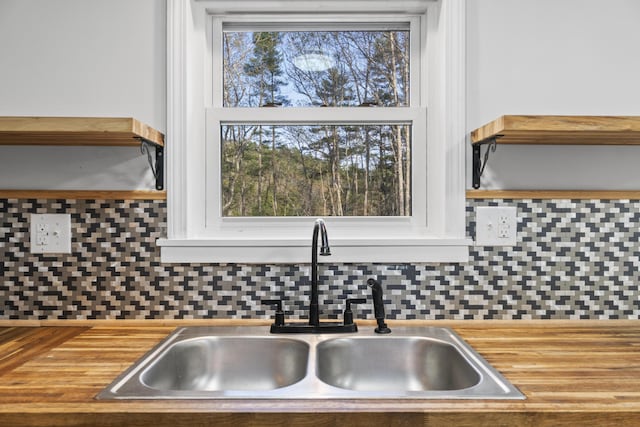 441 Middle Rd, Woolwich, ME 04579 - kitchen featuring a sink, backsplash, and white cabinets