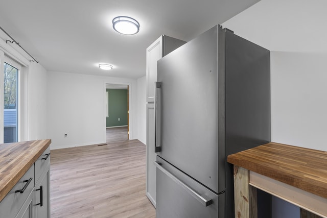 441 Middle Rd, Woolwich, ME 04579 - kitchen featuring freestanding refrigerator, wood counters, light wood finished floors, and baseboards