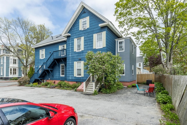 66 Spruce St Unit 1, Portland, ME 04102 - view of front facade featuring stairs and fence