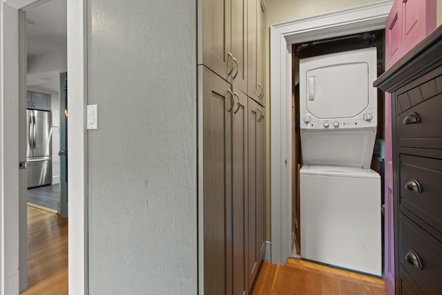 66 Spruce St Unit 1, Portland, ME 04102 - clothes washing area with estacked washer and dryer and light wood-style flooring