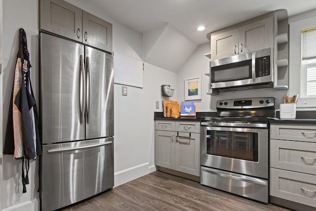 66 Spruce St Unit 1, Portland, ME 04102 - kitchen featuring appliances with stainless steel finishes, dark countertops, dark wood-style flooring, gray cabinets, and baseboards