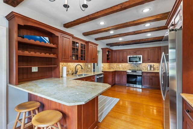 18 Laurel Ln, Eliot, ME 03903 - kitchen with appliances with stainless steel finishes, open shelves, a sink, a peninsula, and light wood-style flooring
