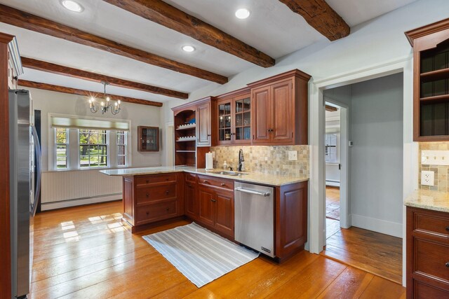 18 Laurel Ln, Eliot, ME 03903 - kitchen featuring baseboard heating, appliances with stainless steel finishes, a sink, light wood finished floors, and a peninsula