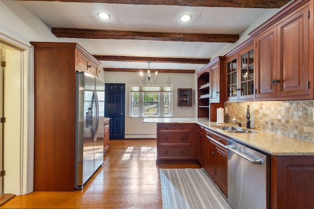 18 Laurel Ln, Eliot, ME 03903 - kitchen with stainless steel appliances, a sink, light wood-style floors, a peninsula, and tasteful backsplash
