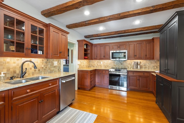 18 Laurel Ln, Eliot, ME 03903 - kitchen with stainless steel appliances, a sink, light stone countertops, backsplash, and light wood-type flooring