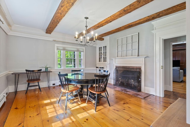 18 Laurel Ln, Eliot, ME 03903 - dining room featuring a fireplace, beam ceiling, light wood-type flooring, a chandelier, and crown molding