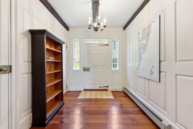 18 Laurel Ln, Eliot, ME 03903 - foyer entrance featuring a baseboard heating unit, a chandelier, a decorative wall, and wood-type flooring