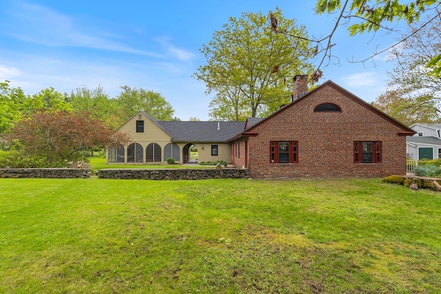18 Laurel Ln, Eliot, ME 03903 - view of front of house featuring a chimney, a front yard, and brick siding
