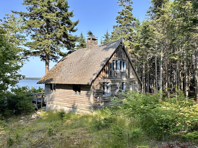 734 Duck Cove Rd, Roque Bluffs, ME 04654 - view of side of home featuring a chimney, a water view, a barn, and log exterior