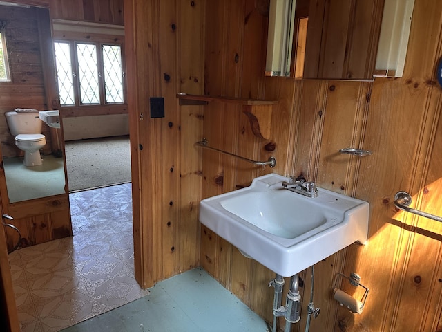 734 Duck Cove Rd, Roque Bluffs, ME 04654 - bathroom with tile patterned floors, toilet, and wood walls