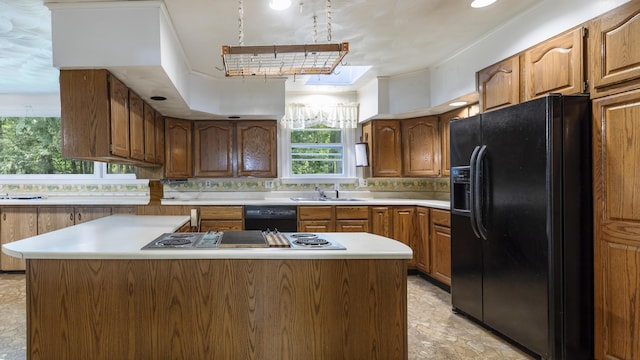 13 Packard Ave, Norway, ME 04268 - kitchen featuring black appliances, a sink, light countertops, and a center island
