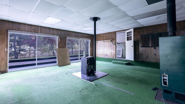 13 Packard Ave, Norway, ME 04268 - below grade area with a wood stove, wooden walls, and carpet floors