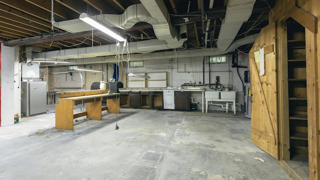 13 Packard Ave, Norway, ME 04268 - unfinished basement with heat pump water heater, a workshop area, and washer / dryer