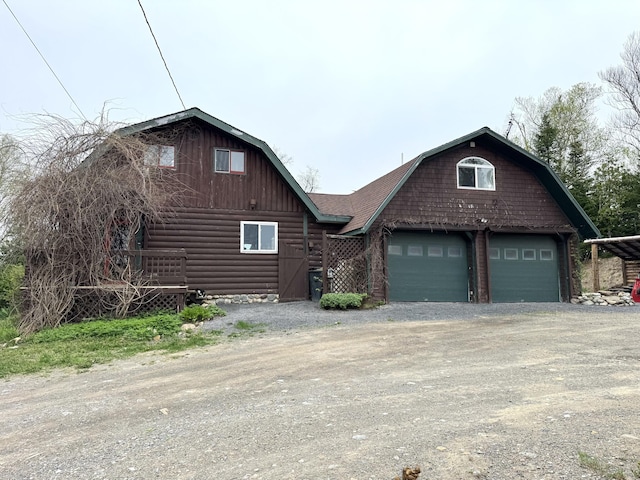135 W Conroy Lake Rd, Monticello, ME 04760 - view of front facade featuring a gambrel roof, a garage, a barn, and dirt driveway