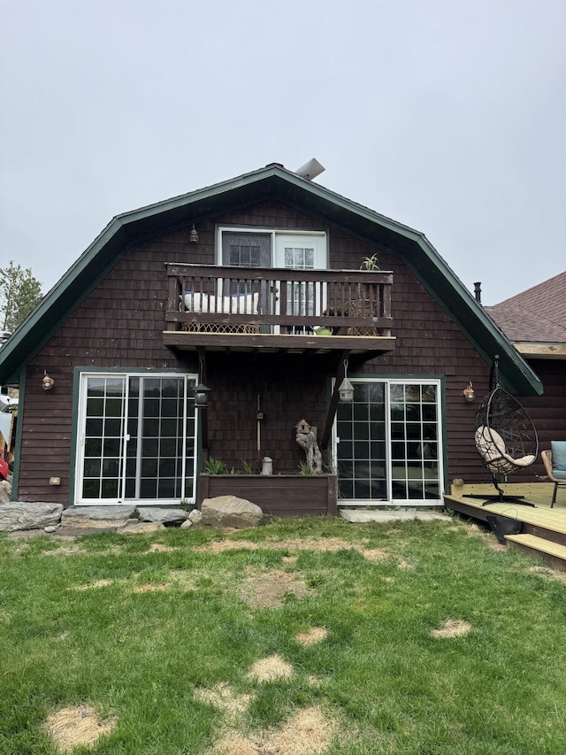 135 W Conroy Lake Rd, Monticello, ME 04760 - back of house featuring a lawn, a balcony, and a shingled roof