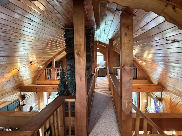 135 W Conroy Lake Rd, Monticello, ME 04760 - hall with wooden walls, wood ceiling, lofted ceiling, an upstairs landing, and carpet flooring