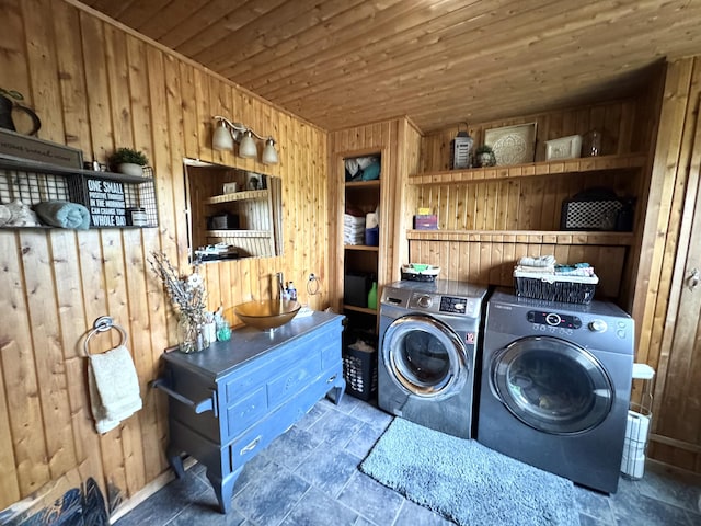 135 W Conroy Lake Rd, Monticello, ME 04760 - laundry room featuring independent washer and dryer, wooden walls, wood ceiling, and stone finish floors