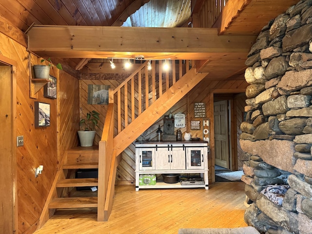 135 W Conroy Lake Rd, Monticello, ME 04760 - stairway featuring wood walls, hardwood / wood-style flooring, and wooden ceiling with exposed beams