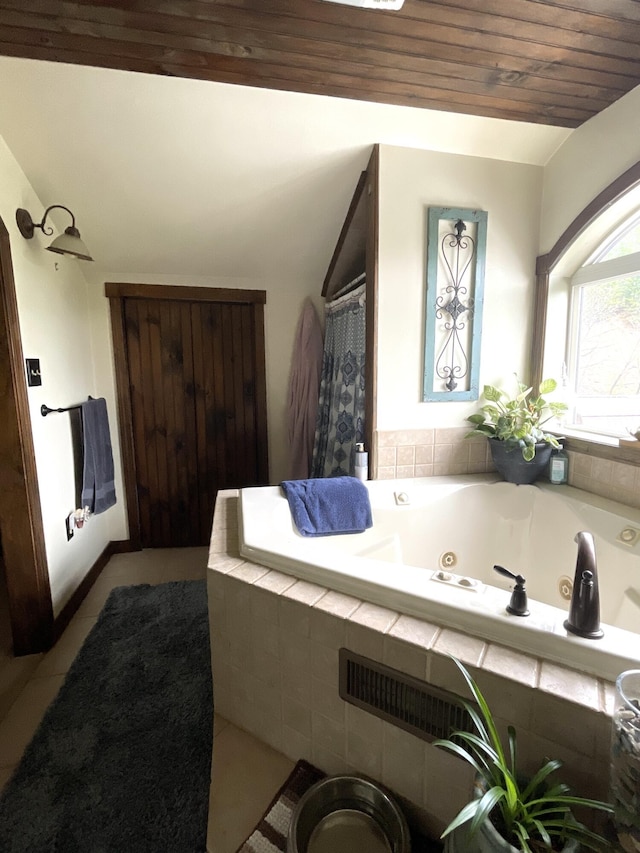 135 W Conroy Lake Rd, Monticello, ME 04760 - bathroom with wood ceiling, a tub with jets, and tile patterned floors