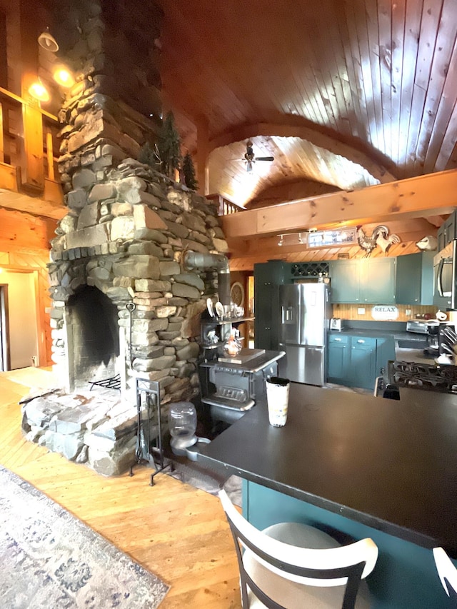 135 W Conroy Lake Rd, Monticello, ME 04760 - kitchen with appliances with stainless steel finishes, wood finished floors, dark countertops, wood ceiling, and vaulted ceiling