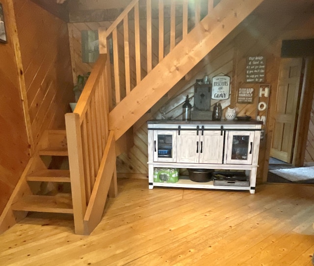 135 W Conroy Lake Rd, Monticello, ME 04760 - bar area featuring hardwood / wood-style floors, wood walls, and stairs