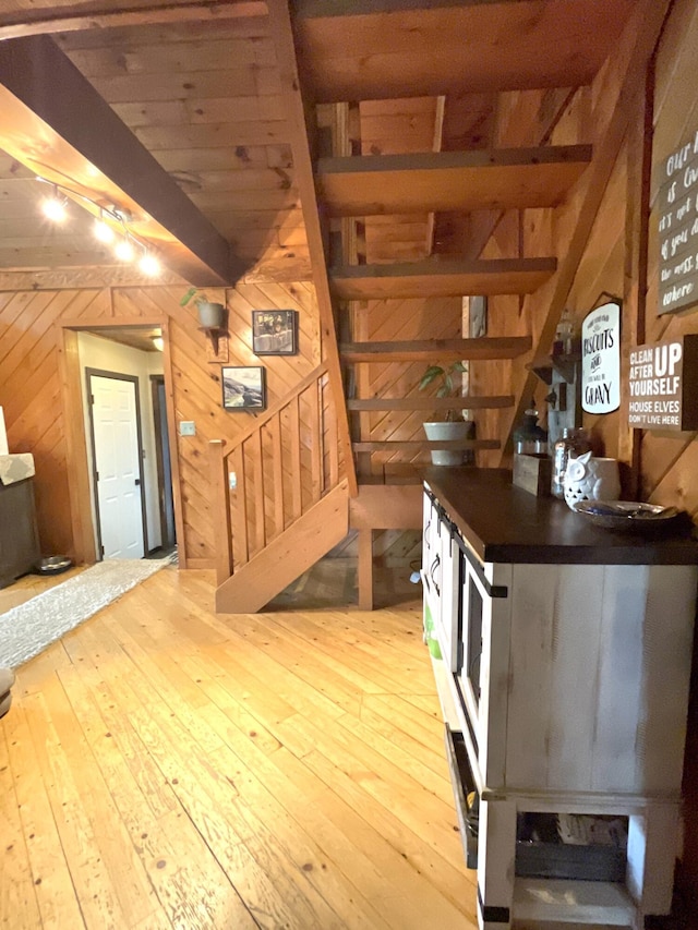135 W Conroy Lake Rd, Monticello, ME 04760 - interior space with stairway, wood walls, hardwood / wood-style flooring, and beam ceiling