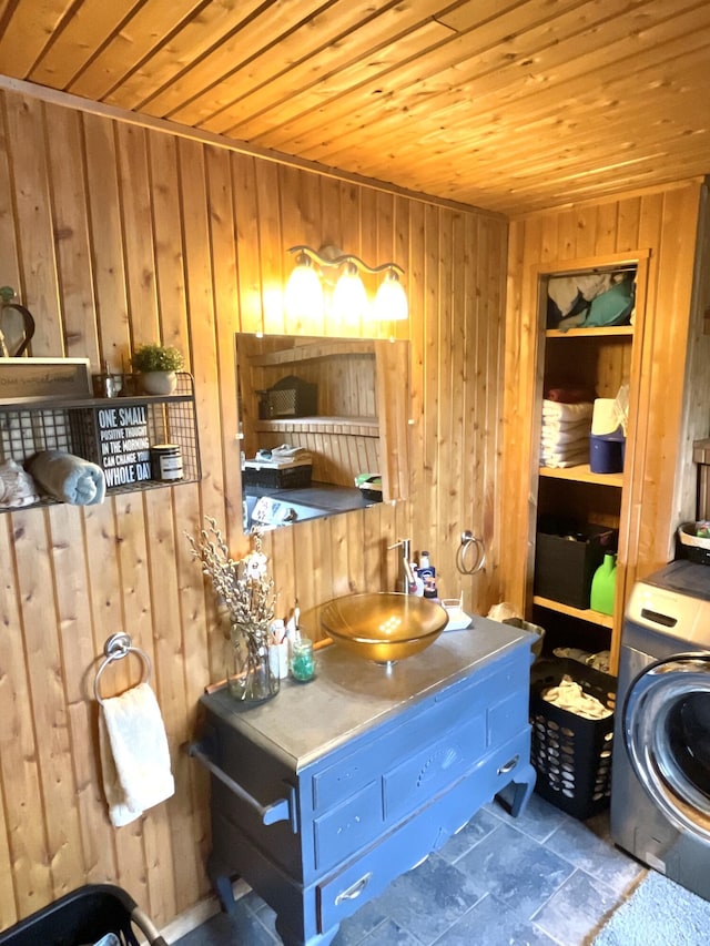 135 W Conroy Lake Rd, Monticello, ME 04760 - bathroom with washer / clothes dryer, wooden walls, wooden ceiling, and stone finish floors