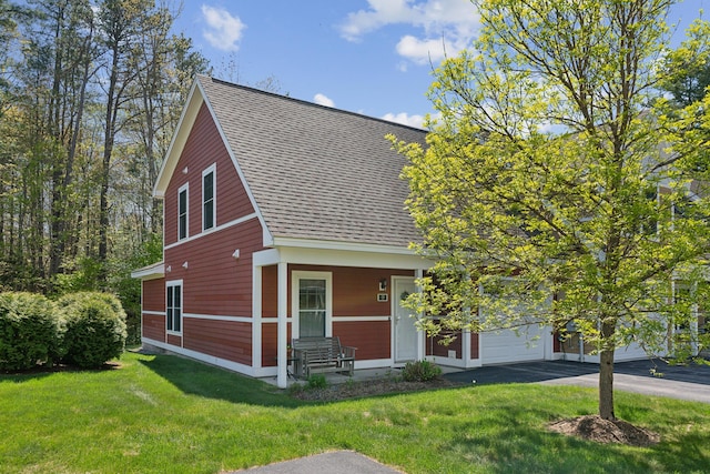 30 Agatha James Dr Unit 11, Kennebunk, ME 04043 - view of front of home featuring roof with shingles, asphalt driveway, a front yard, and a garage