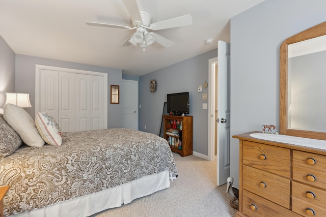 30 Agatha James Dr Unit 11, Kennebunk, ME 04043 - bedroom with light carpet, a closet, baseboards, and ceiling fan