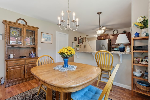 30 Agatha James Dr Unit 11, Kennebunk, ME 04043 - dining room featuring ceiling fan, light wood-style flooring, baseboards, and a chandelier