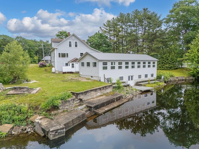 24 Emery Corner Rd, Limerick, ME 04048 - rear view of house with a water view and a lawn