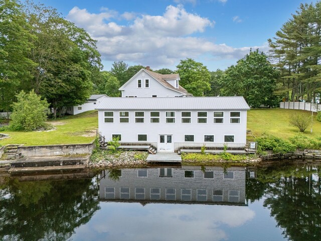 24 Emery Corner Rd, Limerick, ME 04048 - rear view of property with a water view, a lawn, and a metal roof