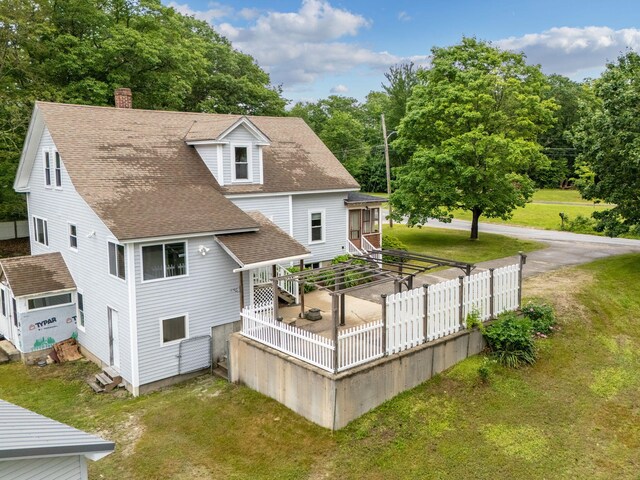 24 Emery Corner Rd, Limerick, ME 04048 - back of property with roof with shingles, a yard, and a chimney