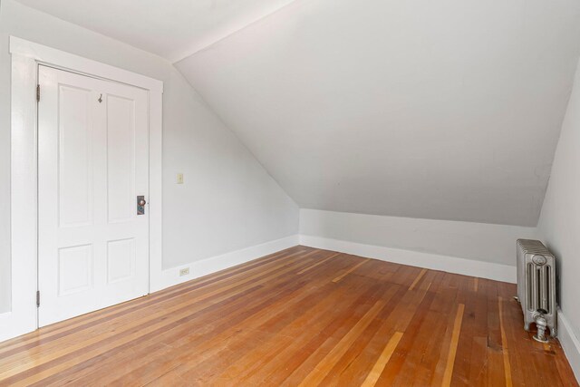 24 Emery Corner Rd, Limerick, ME 04048 - bonus room with radiator, lofted ceiling, and hardwood / wood-style flooring
