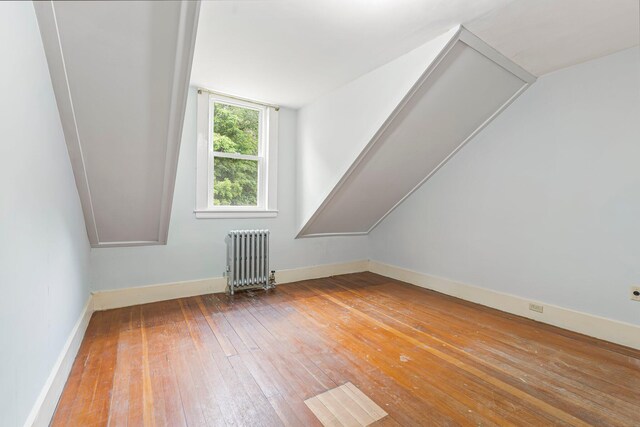 24 Emery Corner Rd, Limerick, ME 04048 - bonus room with radiator, wood-type flooring, and vaulted ceiling