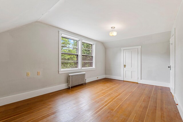 24 Emery Corner Rd, Limerick, ME 04048 - bonus room featuring radiator heating unit, vaulted ceiling, and light wood-style flooring