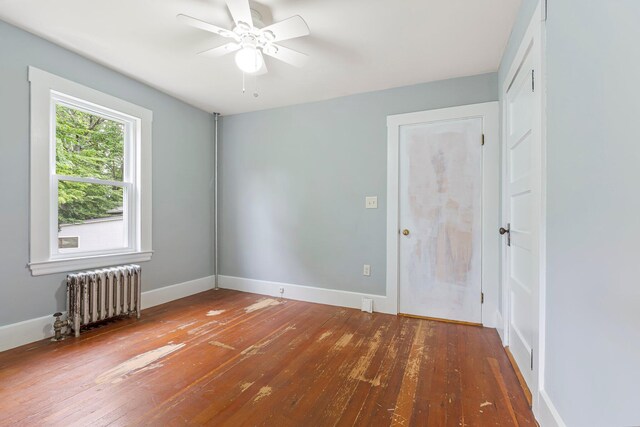 24 Emery Corner Rd, Limerick, ME 04048 - unfurnished room with radiator, a ceiling fan, and wood-type flooring