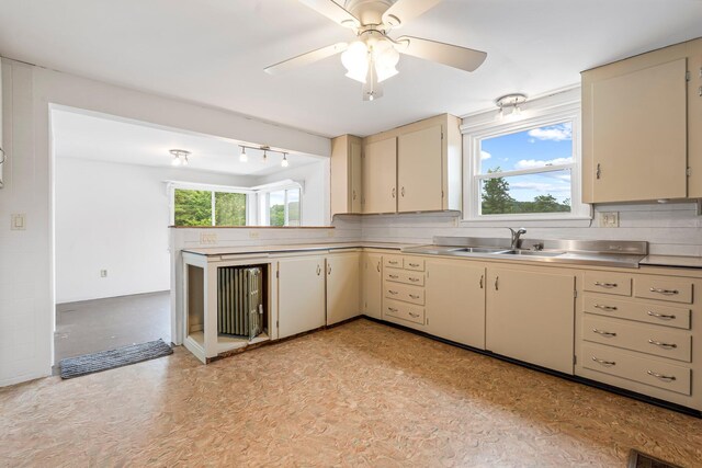 24 Emery Corner Rd, Limerick, ME 04048 - kitchen with cream cabinetry, stainless steel counters, a ceiling fan, and decorative backsplash