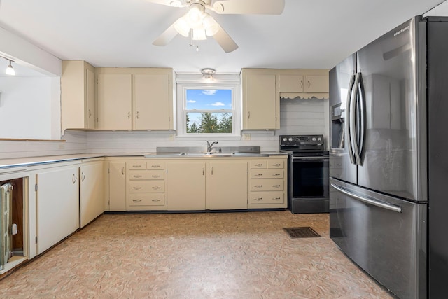 24 Emery Corner Rd, Limerick, ME 04048 - kitchen featuring stainless steel fridge with ice dispenser, cream cabinetry, black electric range oven, light countertops, and ceiling fan