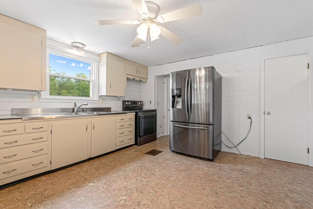 24 Emery Corner Rd, Limerick, ME 04048 - kitchen with stainless steel fridge, stainless steel counters, black / electric stove, cream cabinetry, and a ceiling fan