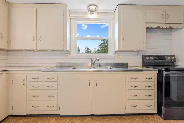 24 Emery Corner Rd, Limerick, ME 04048 - kitchen with black range with electric stovetop and white cabinets