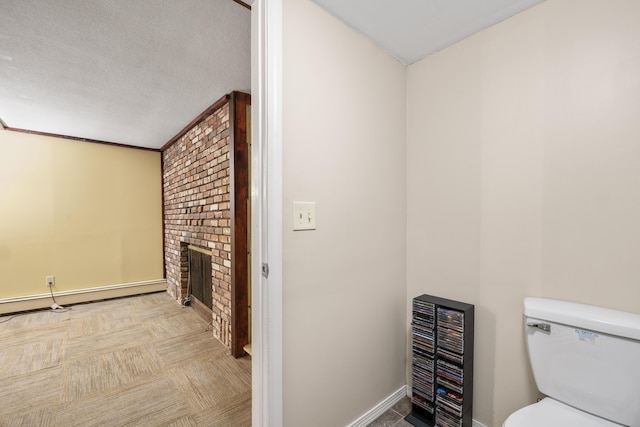 20 Sunderland Dr, Auburn, ME 04210 - bathroom featuring a fireplace, baseboards, toilet, and a baseboard heating unit