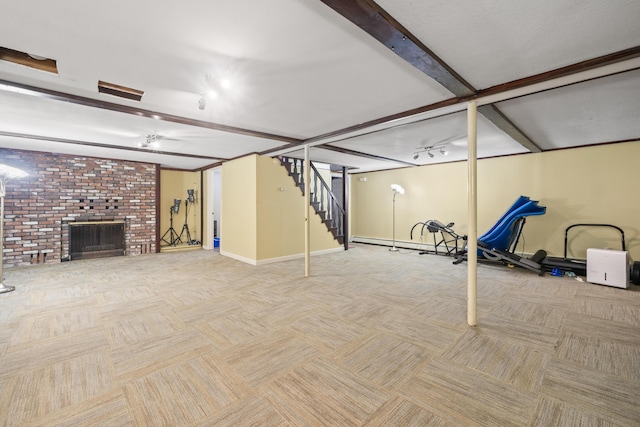 20 Sunderland Dr, Auburn, ME 04210 - finished below grade area with carpet, baseboards, stairway, a brick fireplace, and a baseboard radiator