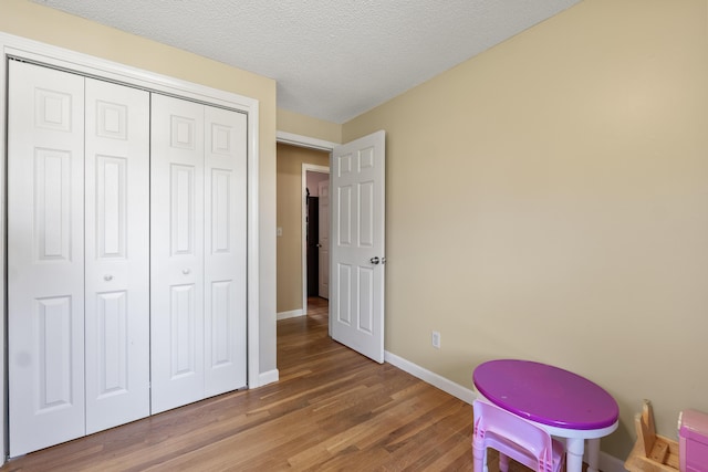 20 Sunderland Dr, Auburn, ME 04210 - playroom featuring wood finished floors, baseboards, and a textured ceiling